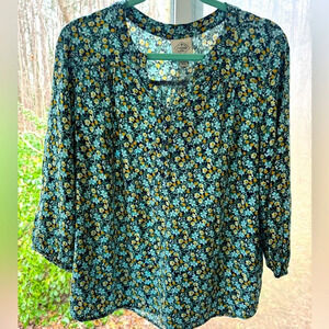St John’s Bay L green multi color blouse. Round collar leading to short “V” neck